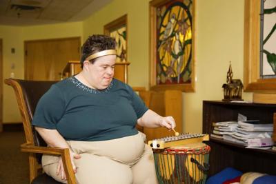 Music Therapy - resident playing drums.jpg